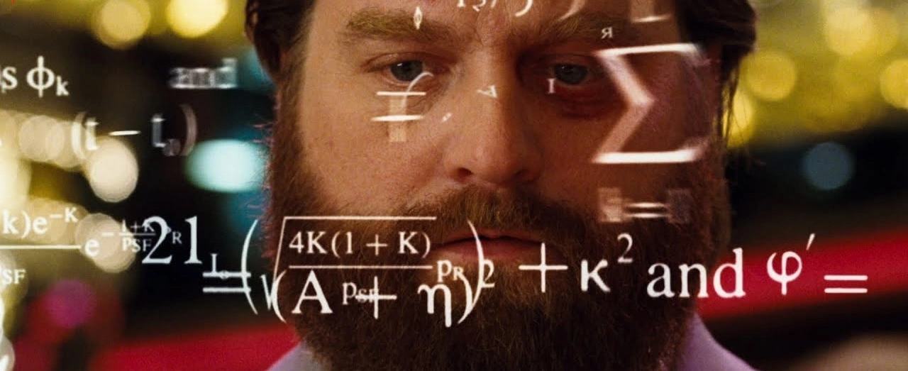 An image of actor Zach Galifianakis from The Hangover thinking hard as math equations fly by his head.